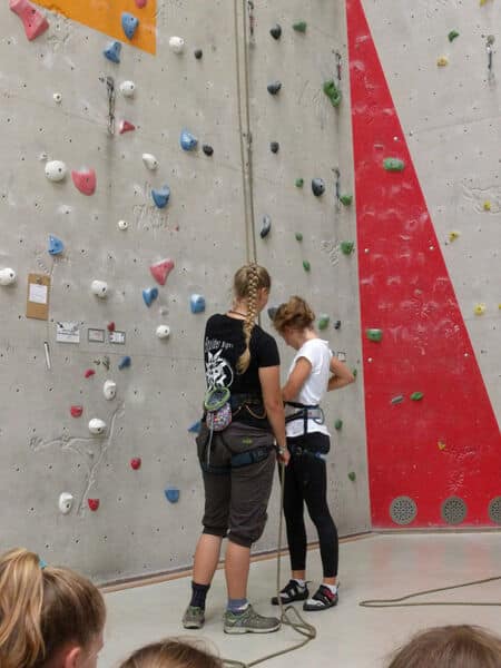 zwei Mädchen, die sich bereit machen zum klettern