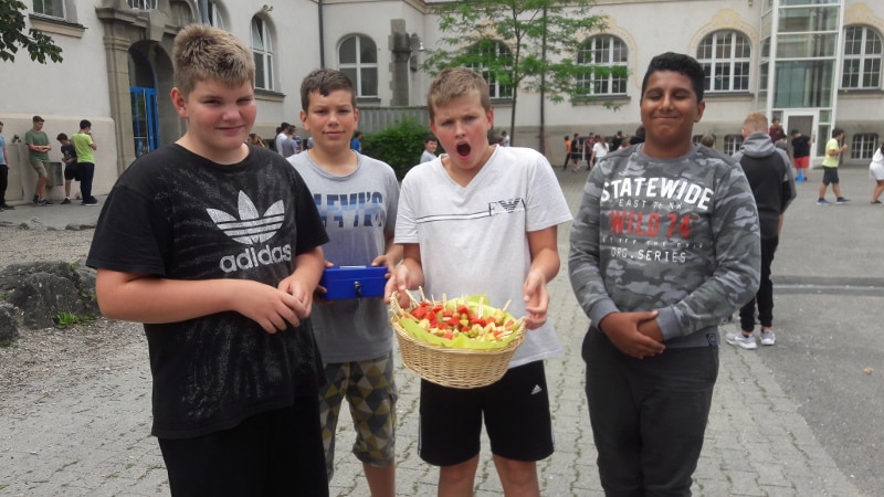 Jungs mit Korb voller Fruchtspieße